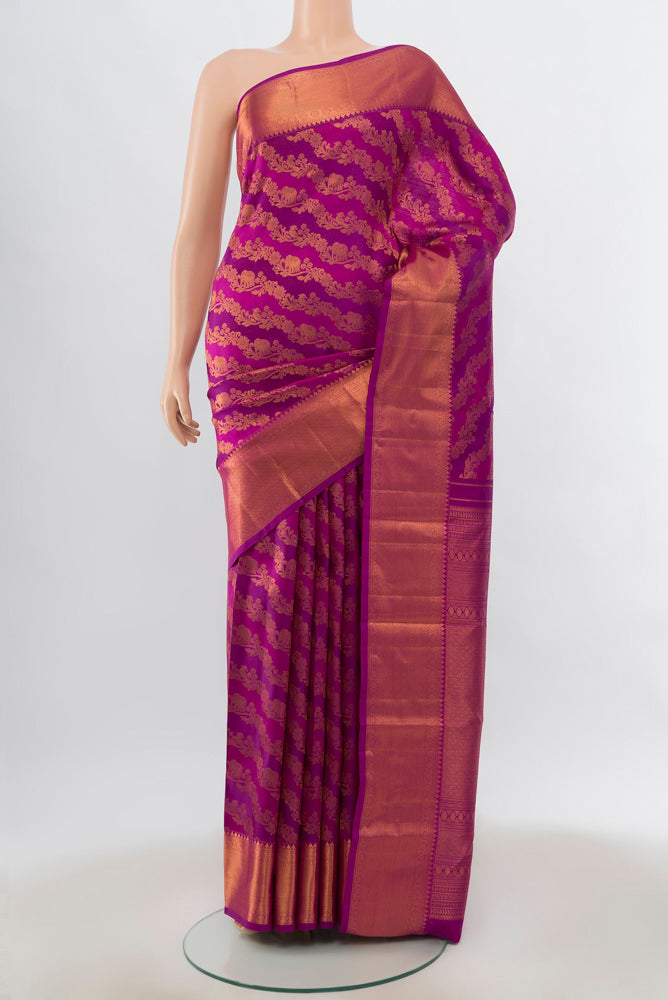 Magenta Kanjivaram Silk Saree with Zari Butta on the body and Silk Border.  displayed on a mannequin