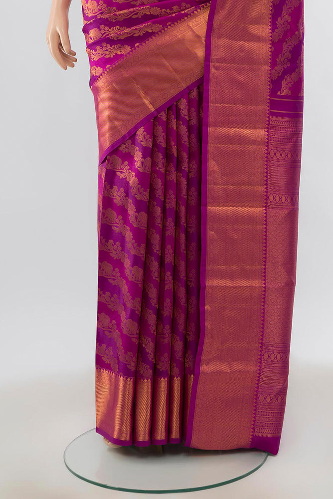 Pleats and pallu of Magenta Kanjivaram Silk Saree with Zari Butta on the body and Silk Border. 