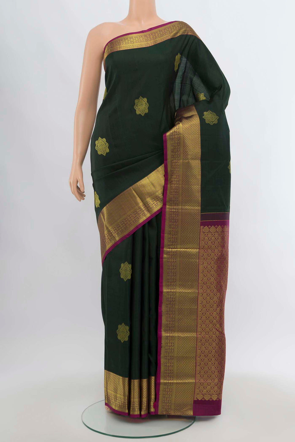 Green Kanchipuram Silk Saree with Zari Butta on the body and Silk Border.  displayed on a mannequin