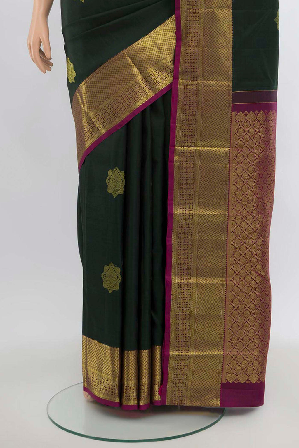 Pleats and pallu of Green Kanchipuram Silk Saree with Zari Butta on the body and Silk Border. 