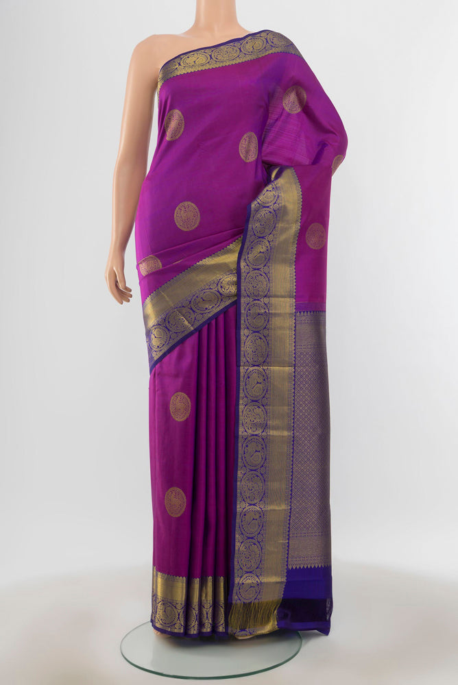 Pure Silk Pure Zari Purple Kanchipuram Saree with Zari Butta on the body and Silk Border.  displayed on a mannequin