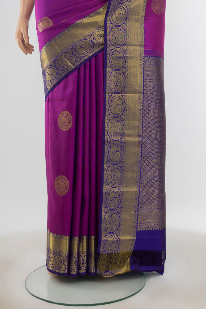 Pleats and pallu of Pure Silk Pure Zari Purple Kanchipuram Saree with Zari Butta on the body and Silk Border. 