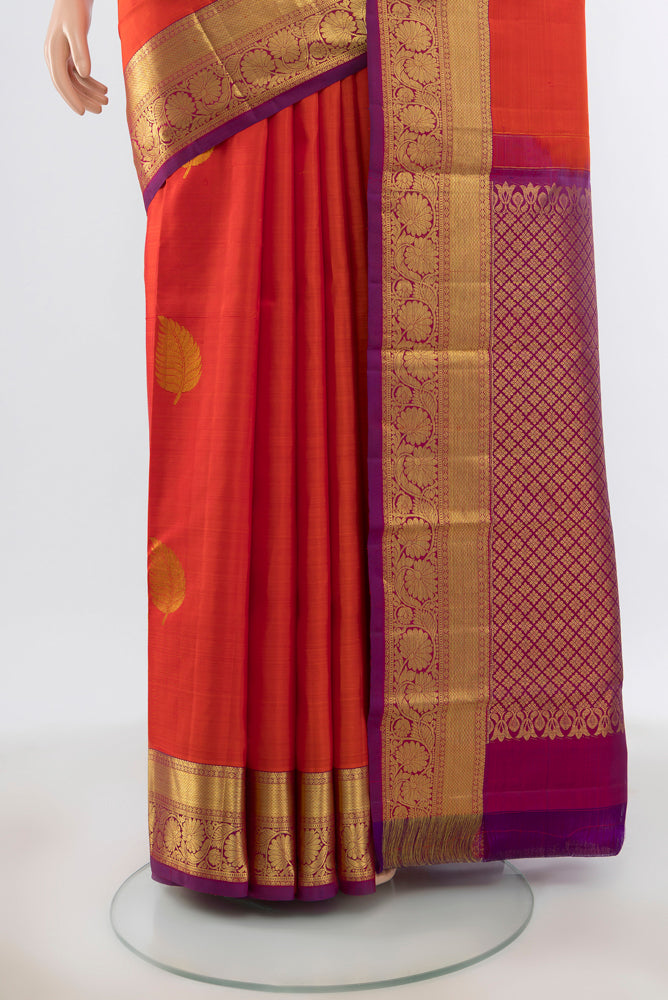 Pleats and pallu of Brick Orange Kanchipuram Silk Saree with Plain Body and Silk Border. 