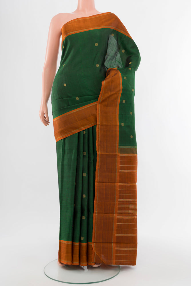 Pure Silk Pure Zari Mint Green Kanjivaram Saree with Zari Butta on the body and Silk Border.  displayed on a mannequin