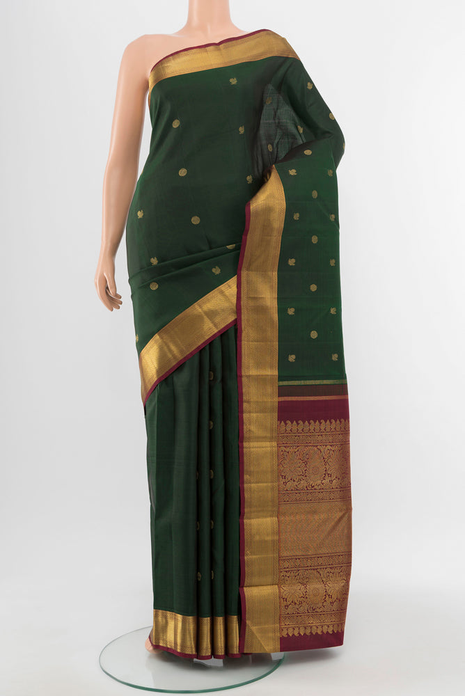 Pure Silk Pure Zari Mint Green Kanchipuram Saree with Zari Butta on the body and Silk Border.  displayed on a mannequin