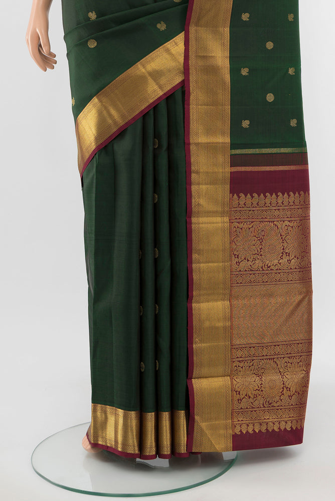 Pleats and pallu of Pure Silk Pure Zari Mint Green Kanchipuram Saree with Zari Butta on the body and Silk Border. 