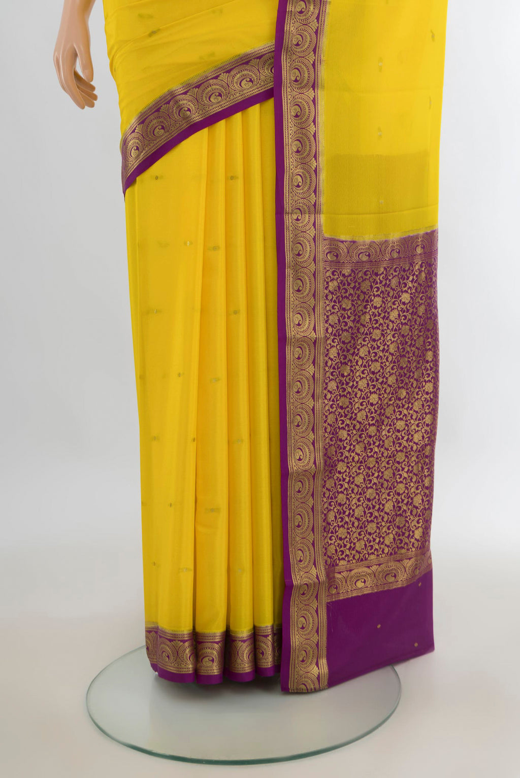 Pleats and pallu of Yellow Mysore Crepe Saree with Zari Butta on the body and Zari Border. 