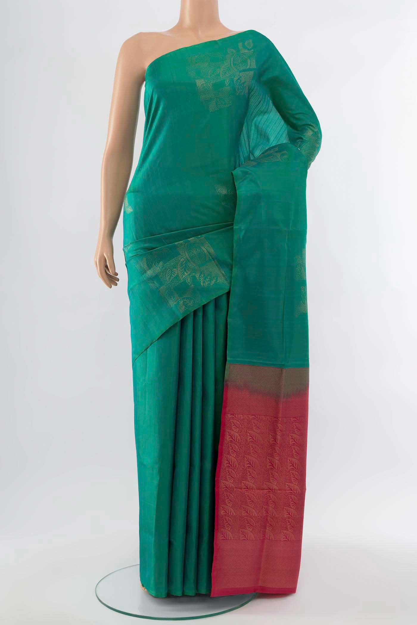 Light Green Soft Silk Saree with Zari Butta on the body and Silk Border displayed on a mannequin