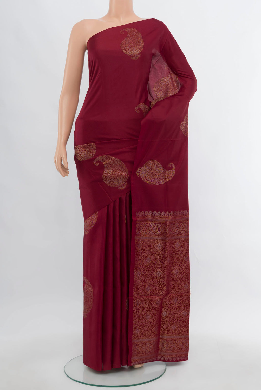 Maroon Soft Silk Saree with Zari Butta on the body and Silk Border.  displayed on a mannequin
