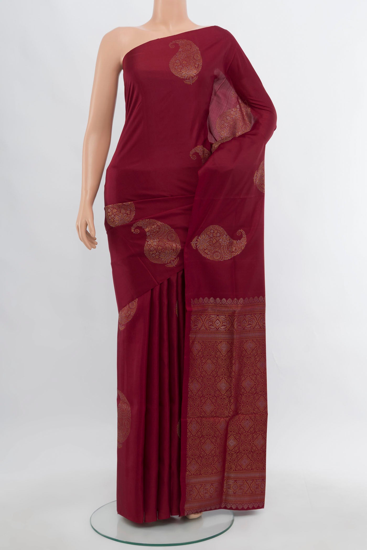 Maroon Soft Silk Saree with Zari Butta on the body and Silk Border.  displayed on a mannequin