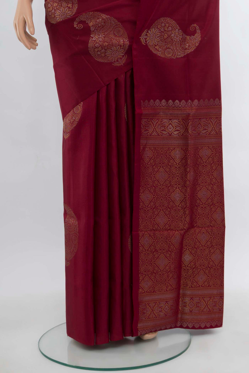 Pleats and pallu of Maroon Soft Silk Saree with Zari Butta on the body and Silk Border. 