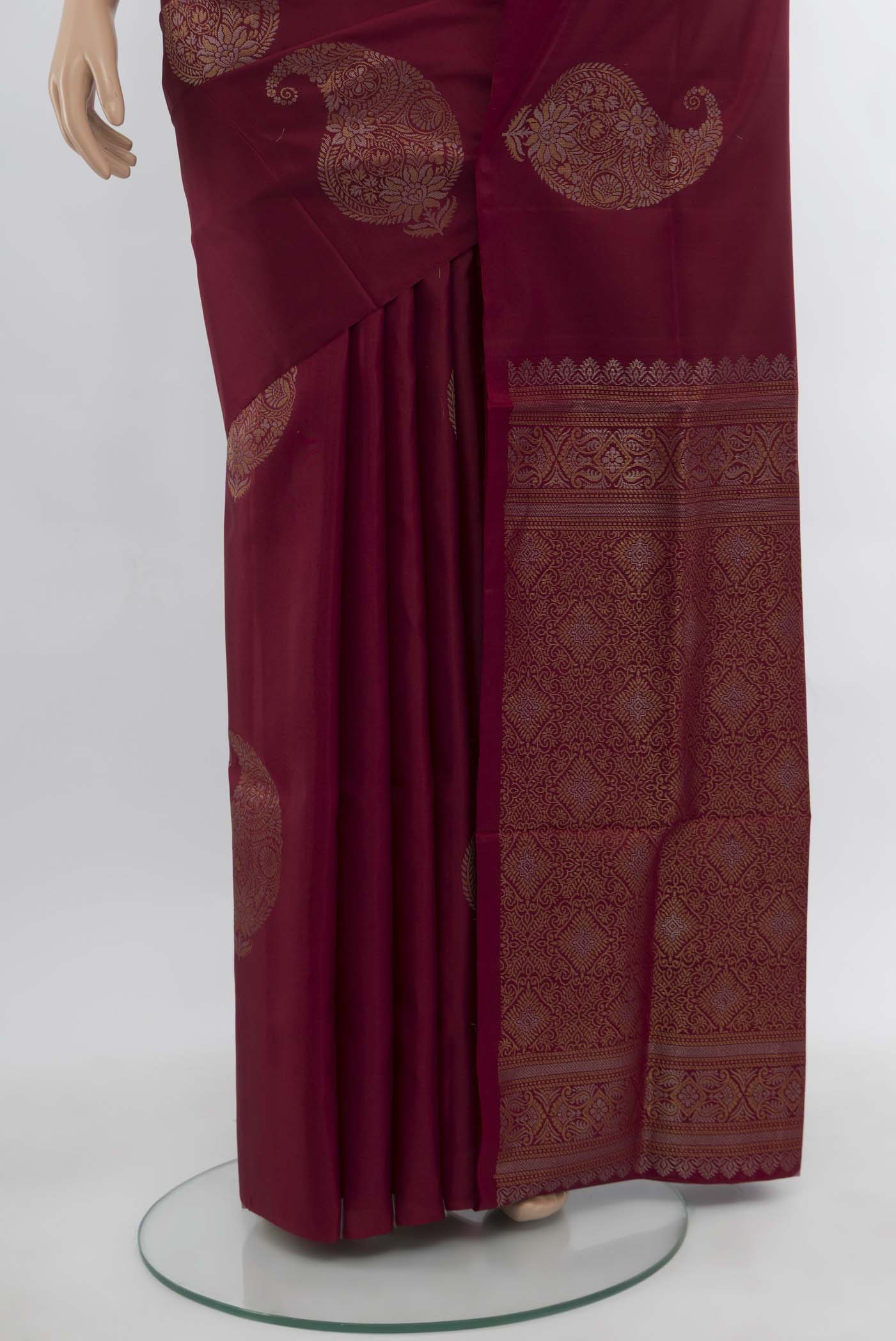 Pleats and pallu of Maroon Soft Silk Saree with Zari Butta on the body and Silk Border. 