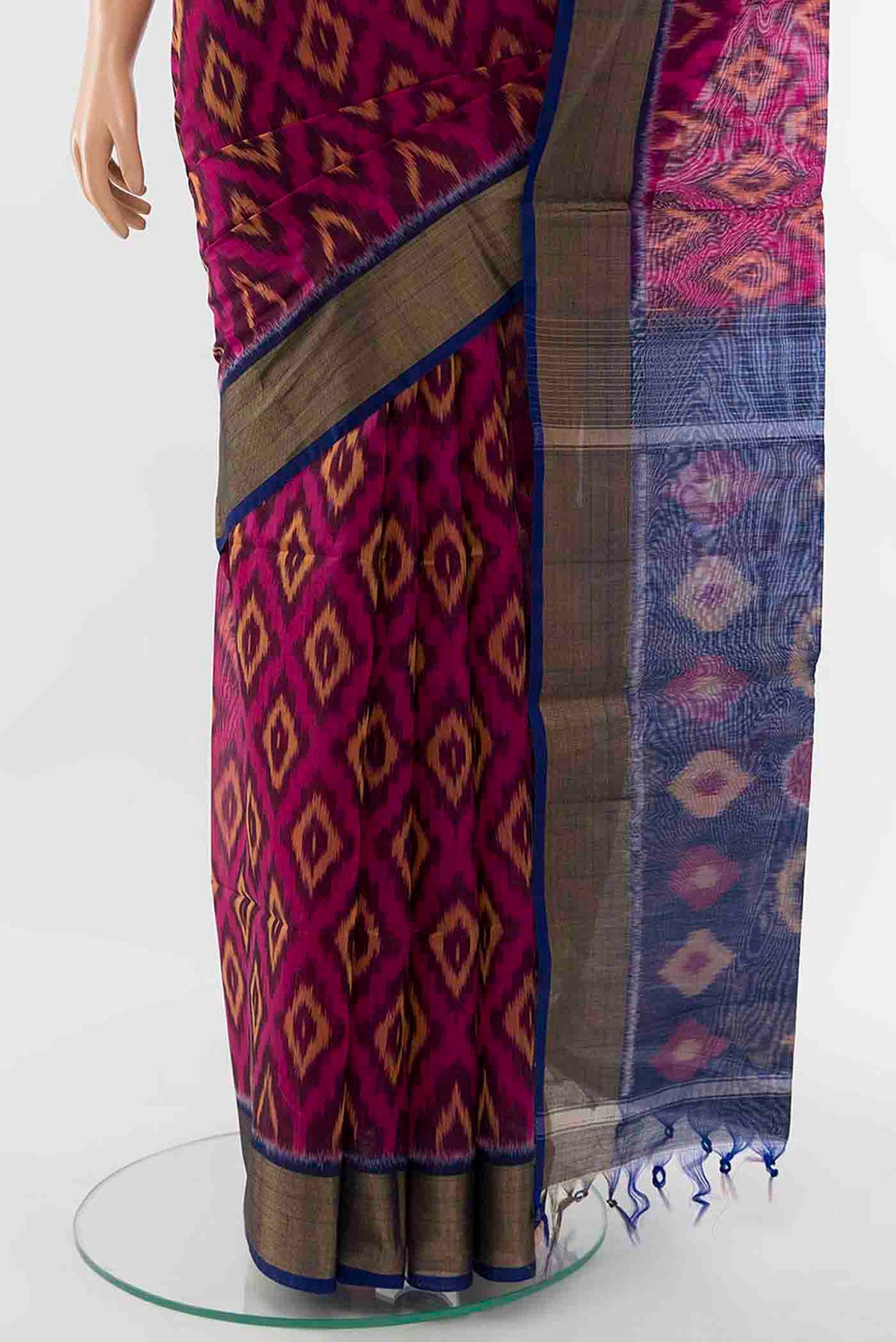 Pleats and pallu of Magenta Kora Cotton Saree with Ikat Print on the body and Ikat Border