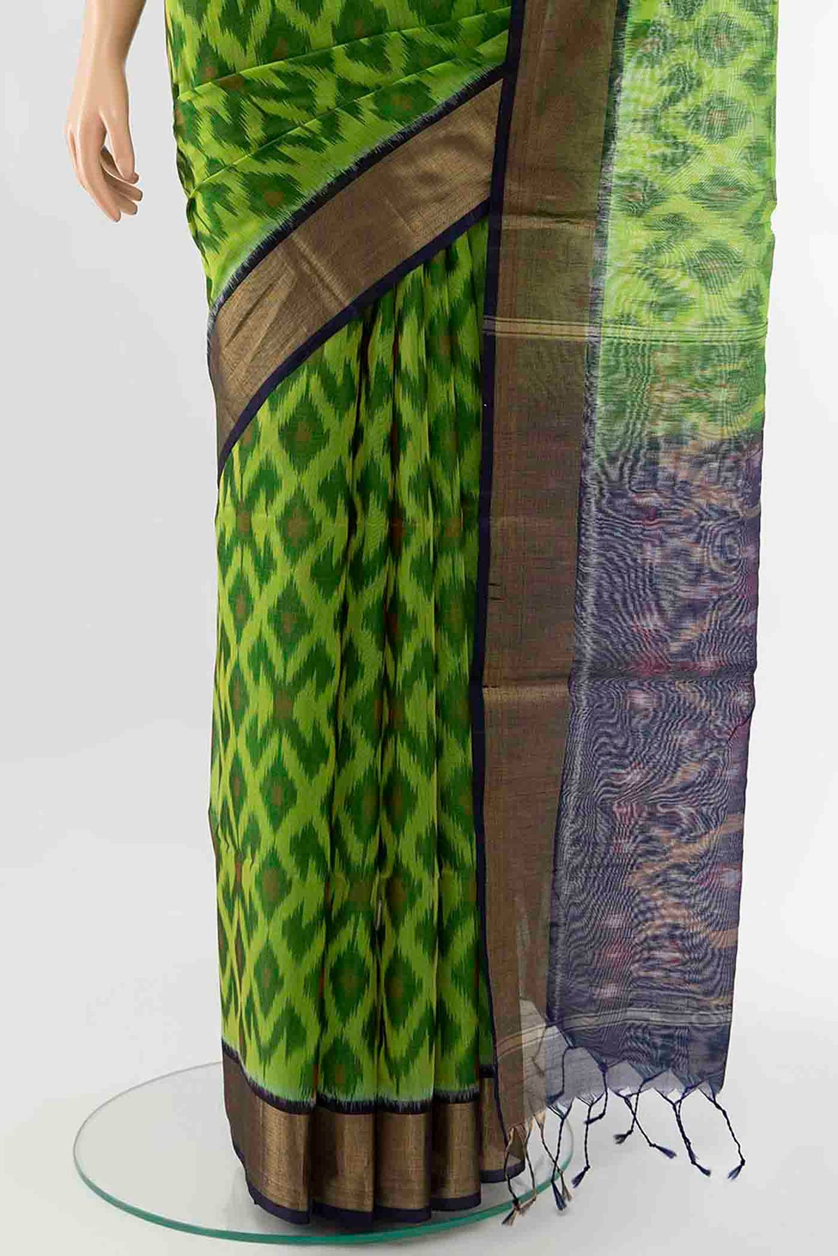 Pleats and pallu of Parrot Green Kora Cotton Saree with Ikat Print on the body and Ikat Border