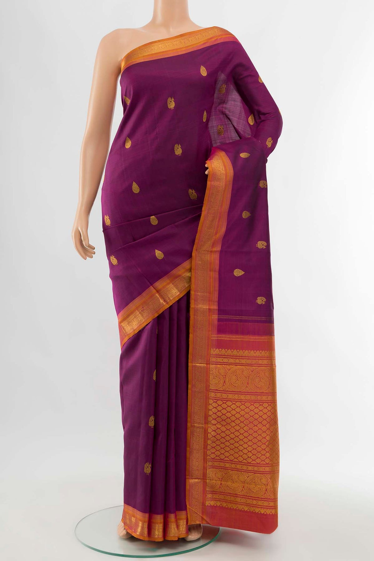 Magenta Kanchipuram Silk Saree with Zari Butta on the body and Silk Border displayed on a mannequin