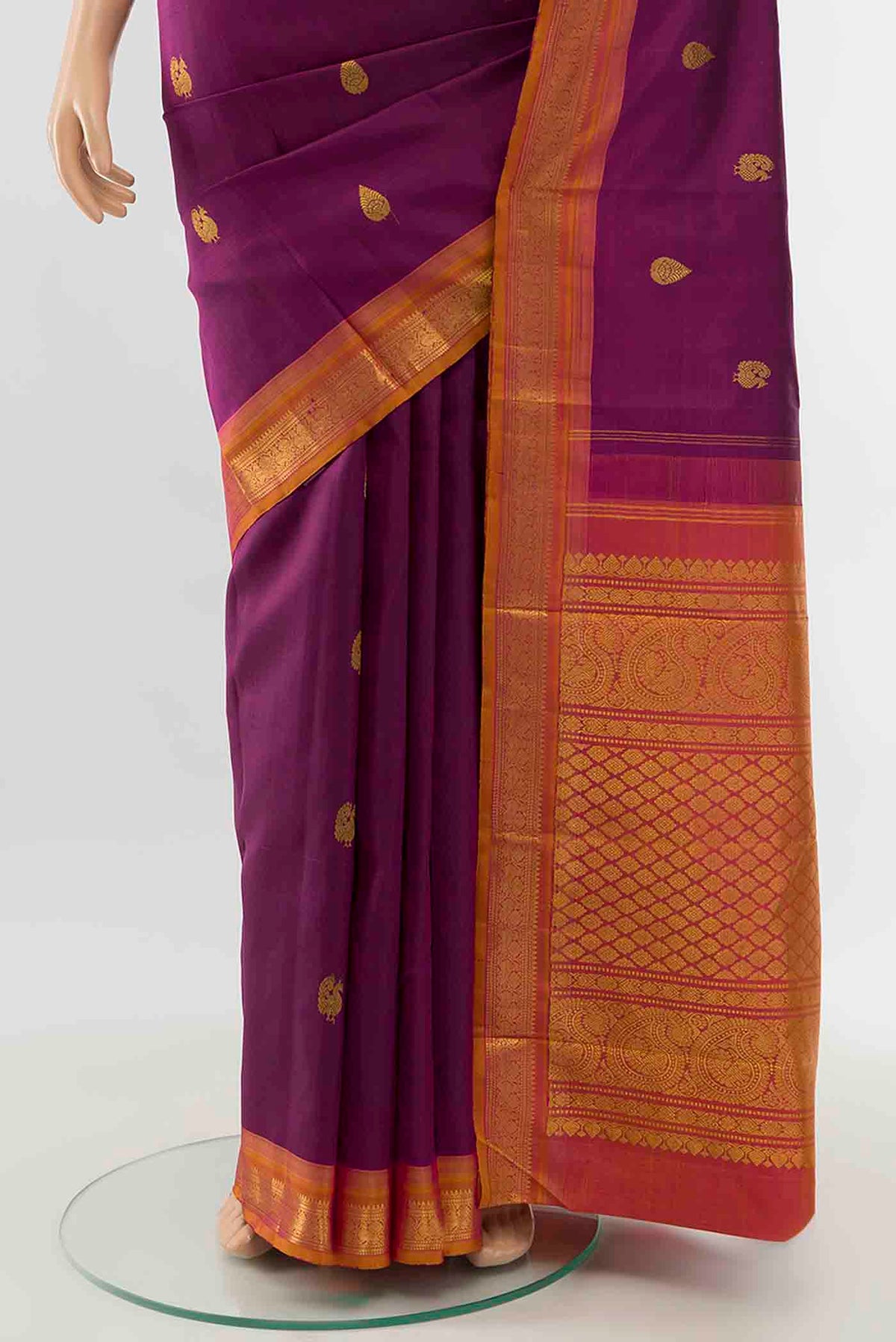 Pleats and pallu of Magenta Kanchipuram Silk Saree with Zari Butta on the body and Silk Border