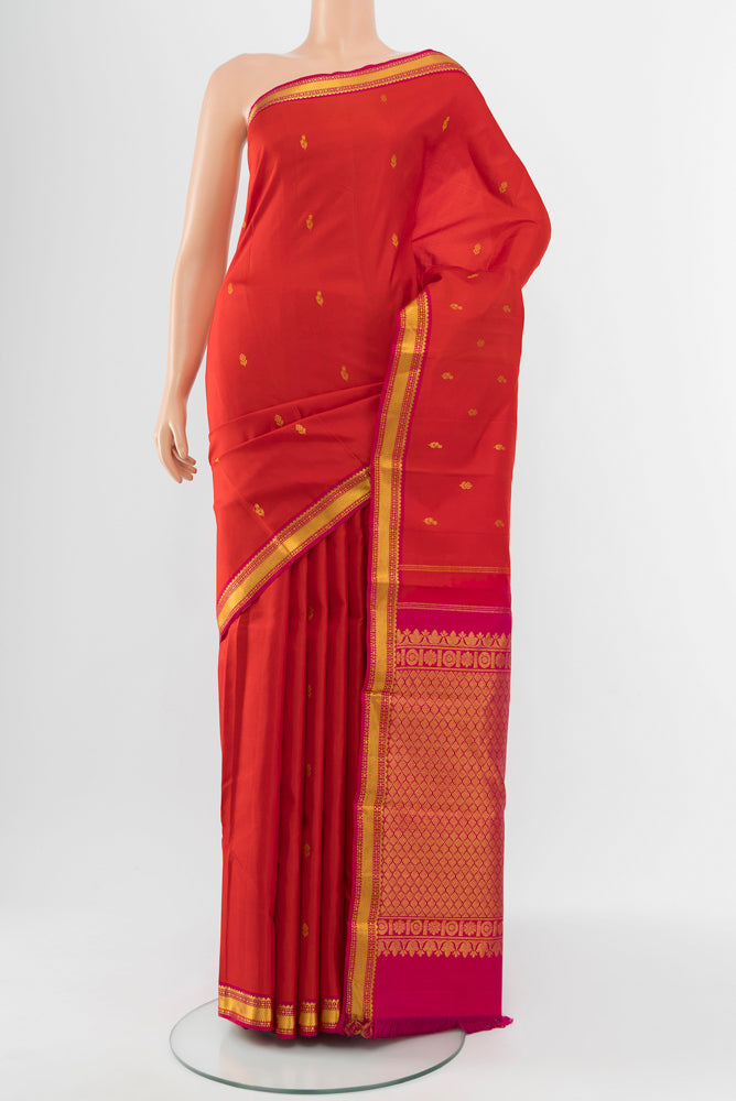 Red Kanchipuram Silk Saree with Zari Butta on the body and Silk Border.  displayed on a mannequin