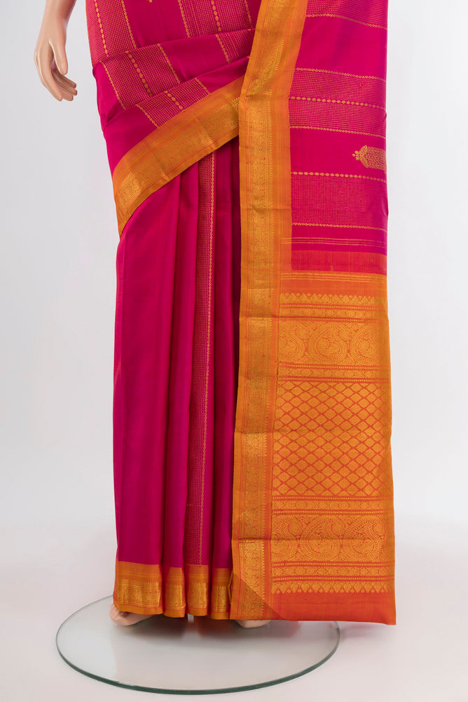 Pleats and pallu of Dark Pink Kanjivaram Silk Saree with Zari Butta on the body and Silk Border. 