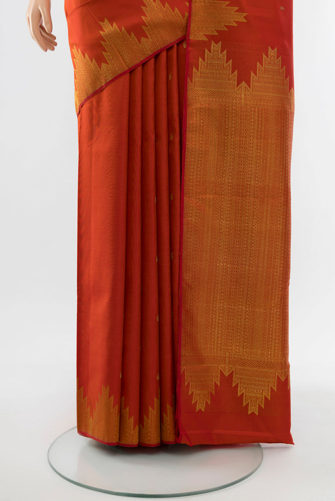 Pleats and pallu of Rust Kanchipuram Silk Saree with Zari Butta on the body and Silk Border. 