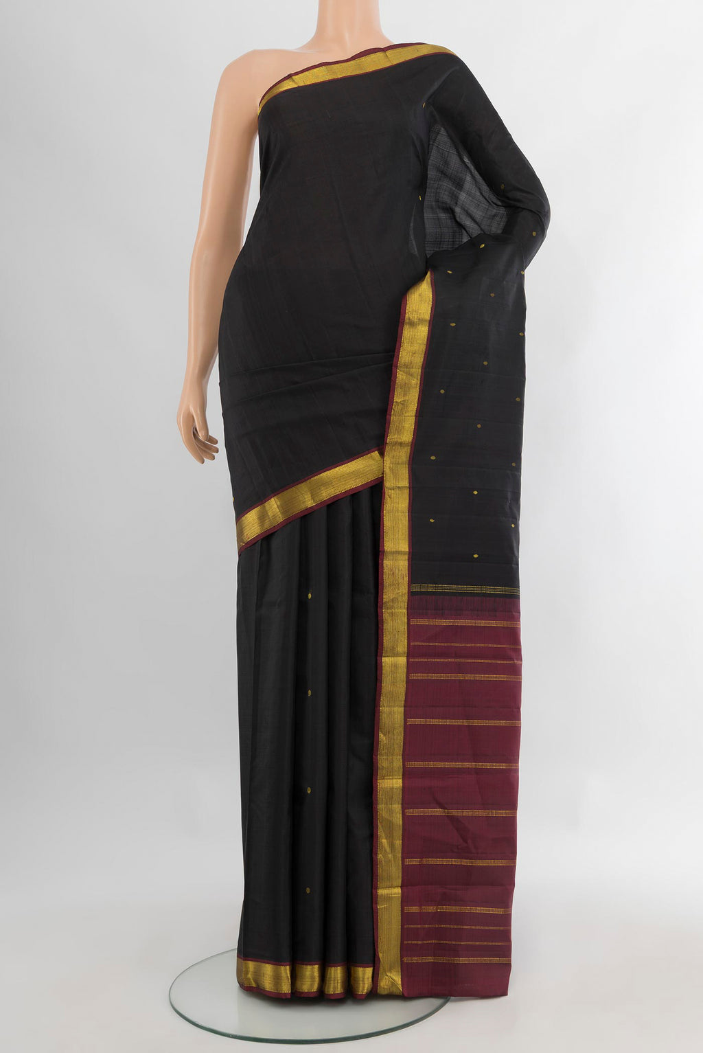 Black Kanjivaram Silk Saree with Zari Butta on the body and Zari Border.  displayed on a mannequin