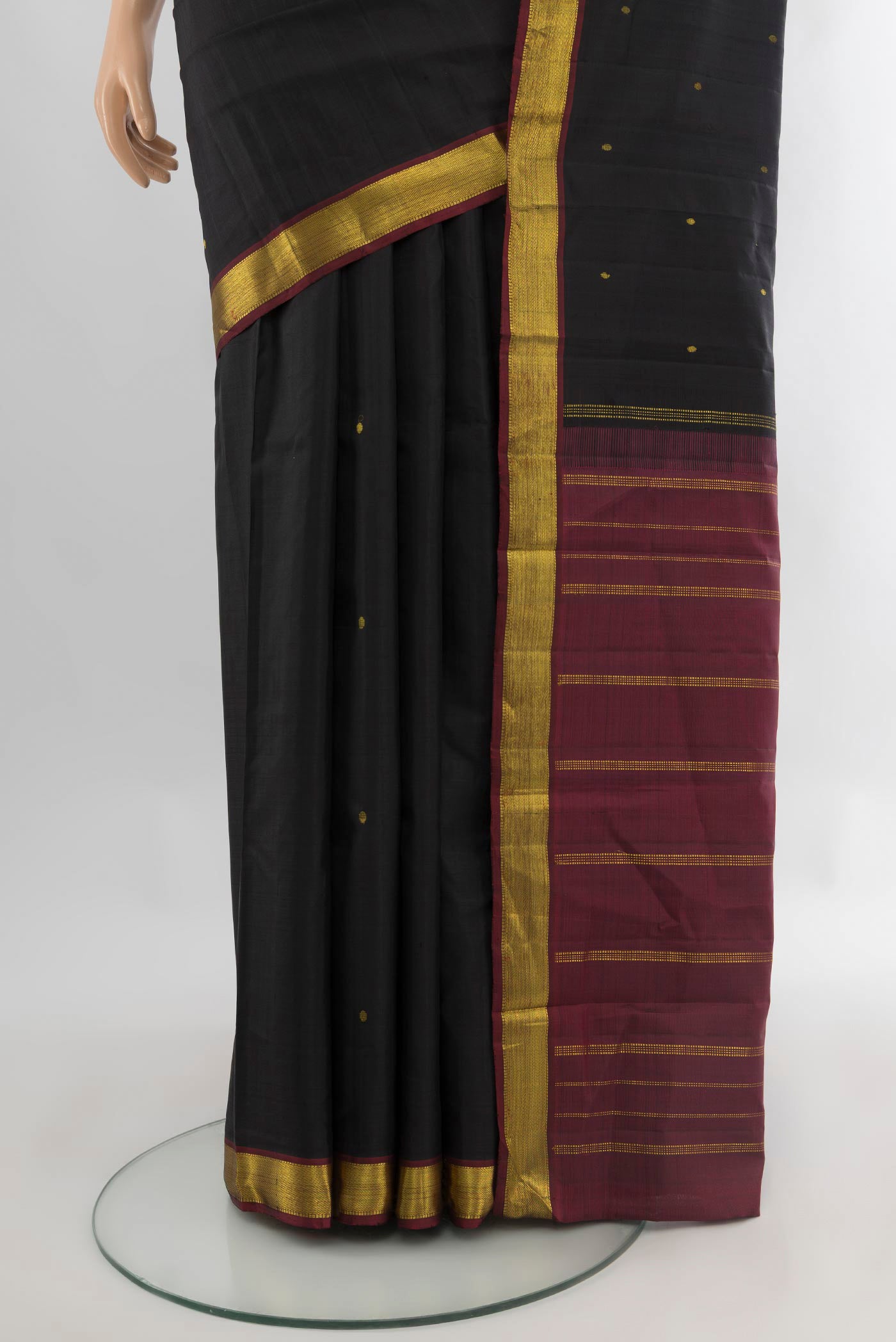 Pleats and pallu of Black Kanjivaram Silk Saree with Zari Butta on the body and Zari Border. 
