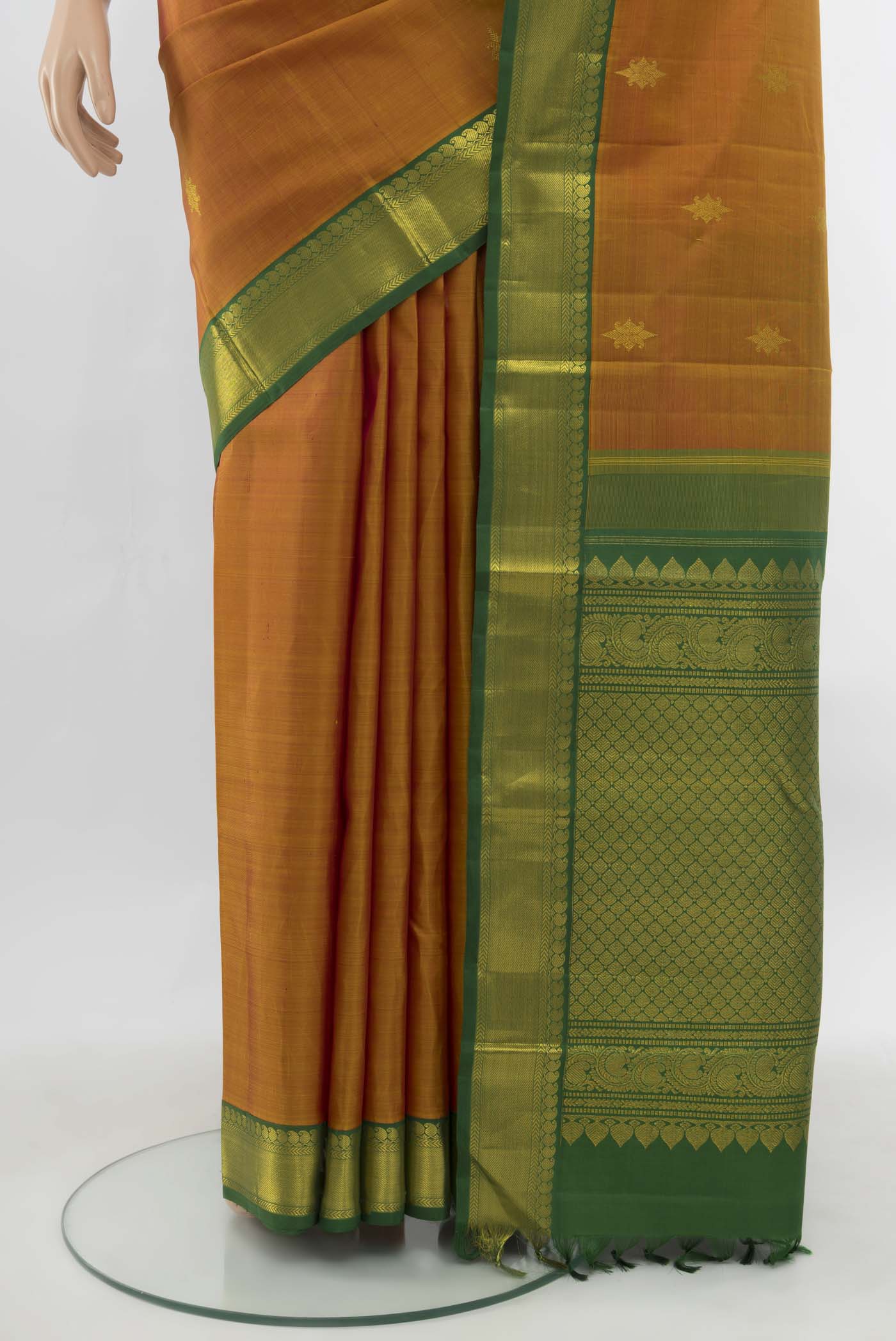 Pleats and pallu of Pure Silk Pure Zari Rust Kanjivaram Saree with Zari Butta on the body and Silk Border. 
