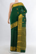 Bottle Green Kanjivaram Silk Saree with Zari Butta on the body and Zari Border.  displayed on a mannequin