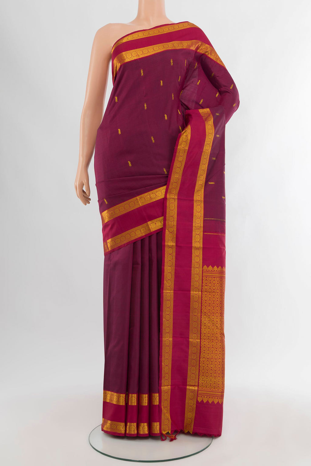Maroon Kanchipuram Silk Saree with Zari Butta on the body and Zari Border.  displayed on a mannequin