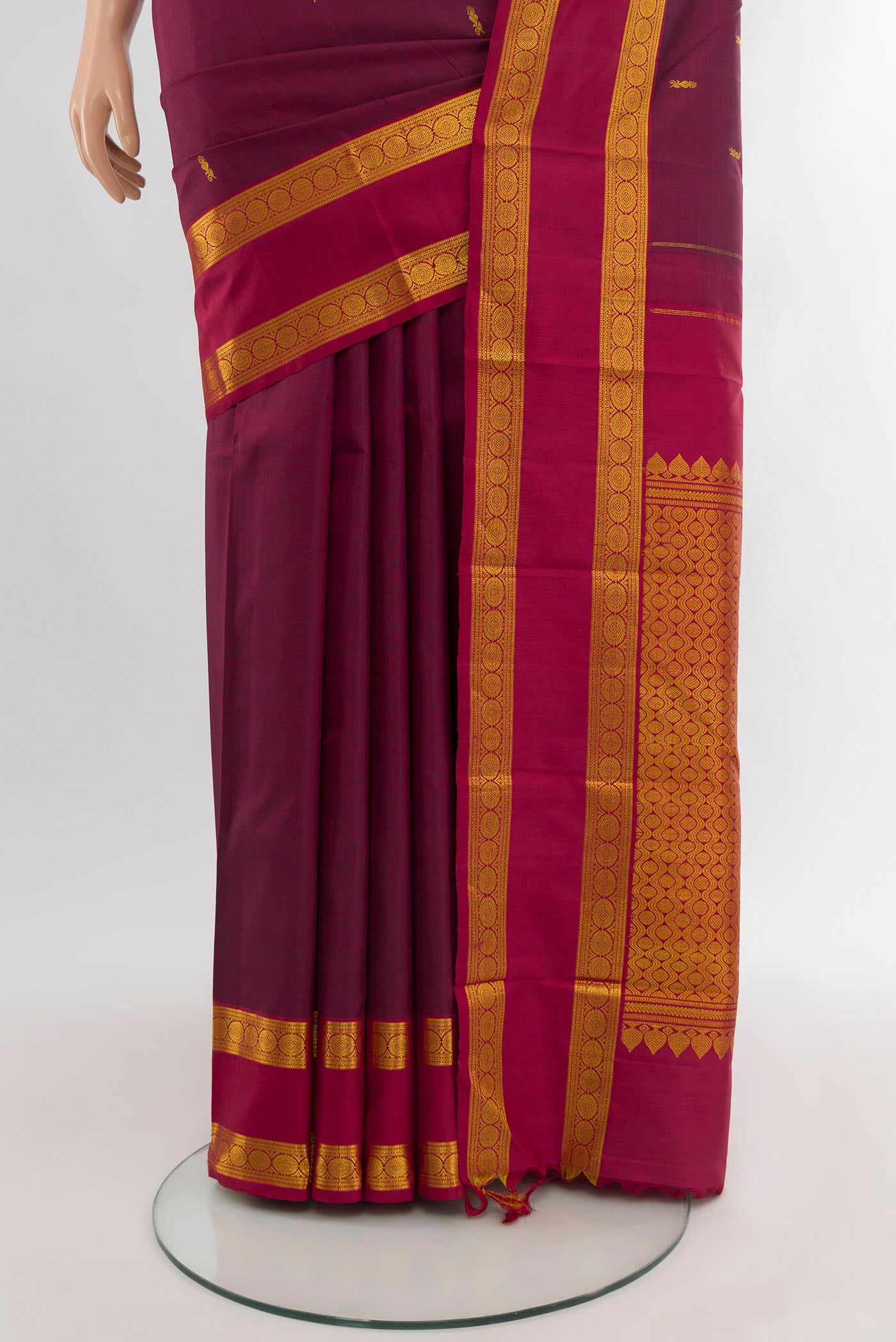 Pleats and pallu of Maroon Kanchipuram Silk Saree with Zari Butta on the body and Zari Border. 
