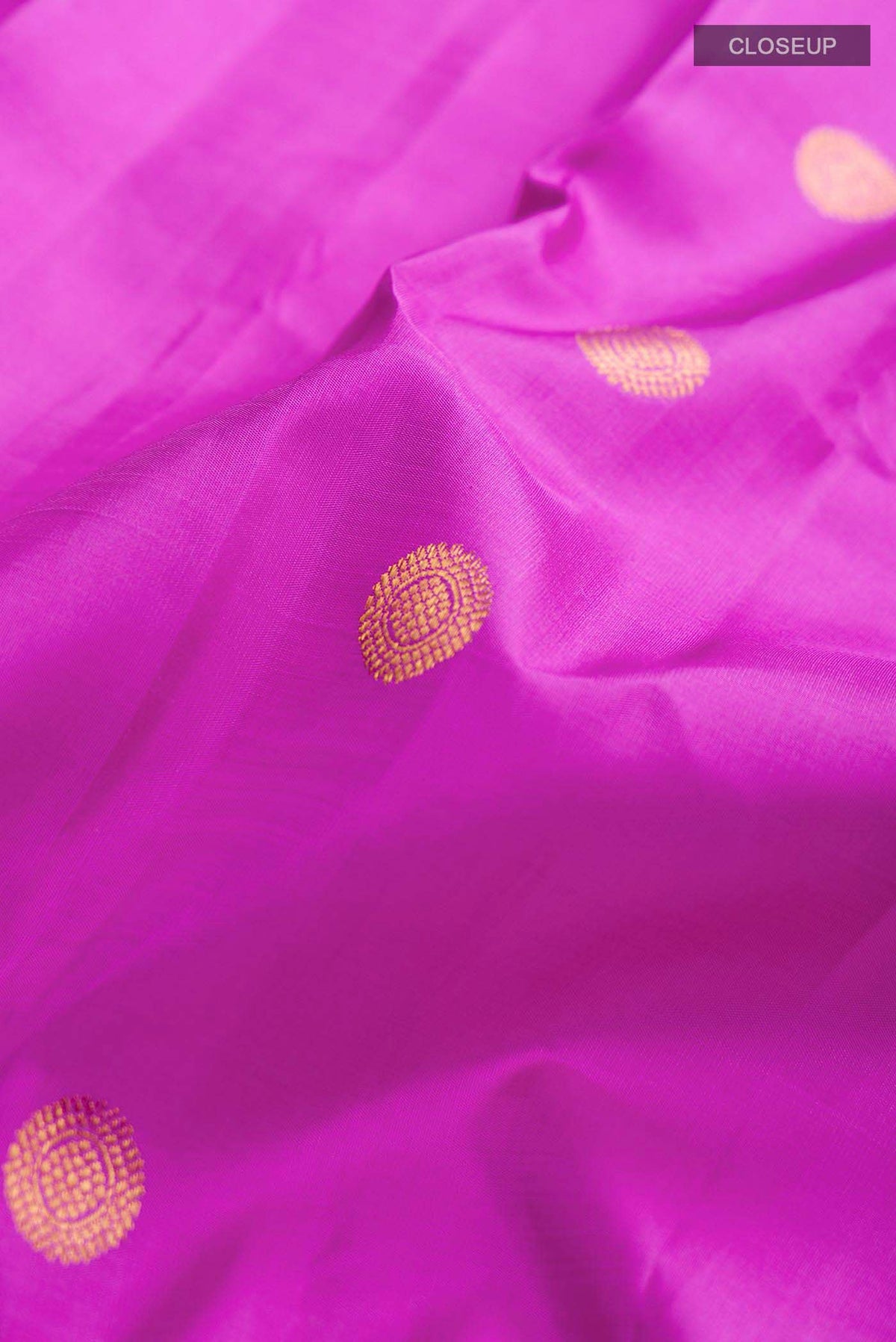 Close up of Violet Kanchipuram Silk Saree with Zari Butta on the body and Zari Border displaying folds