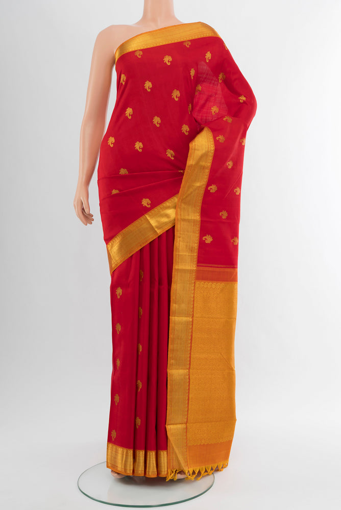 Pure Silk Pure Zari Red Kanjivaram Saree with Zari Butta on the body and Silk Border.  displayed on a mannequin
