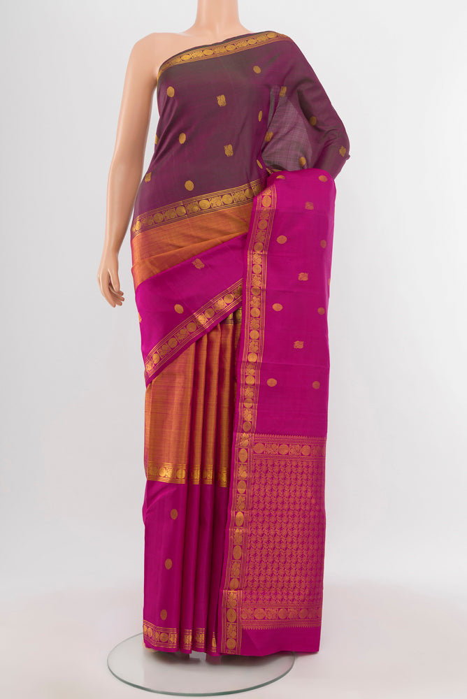 Golden Kanjivaram Silk Saree with Zari Butta on the body and Silk Border.  displayed on a mannequin