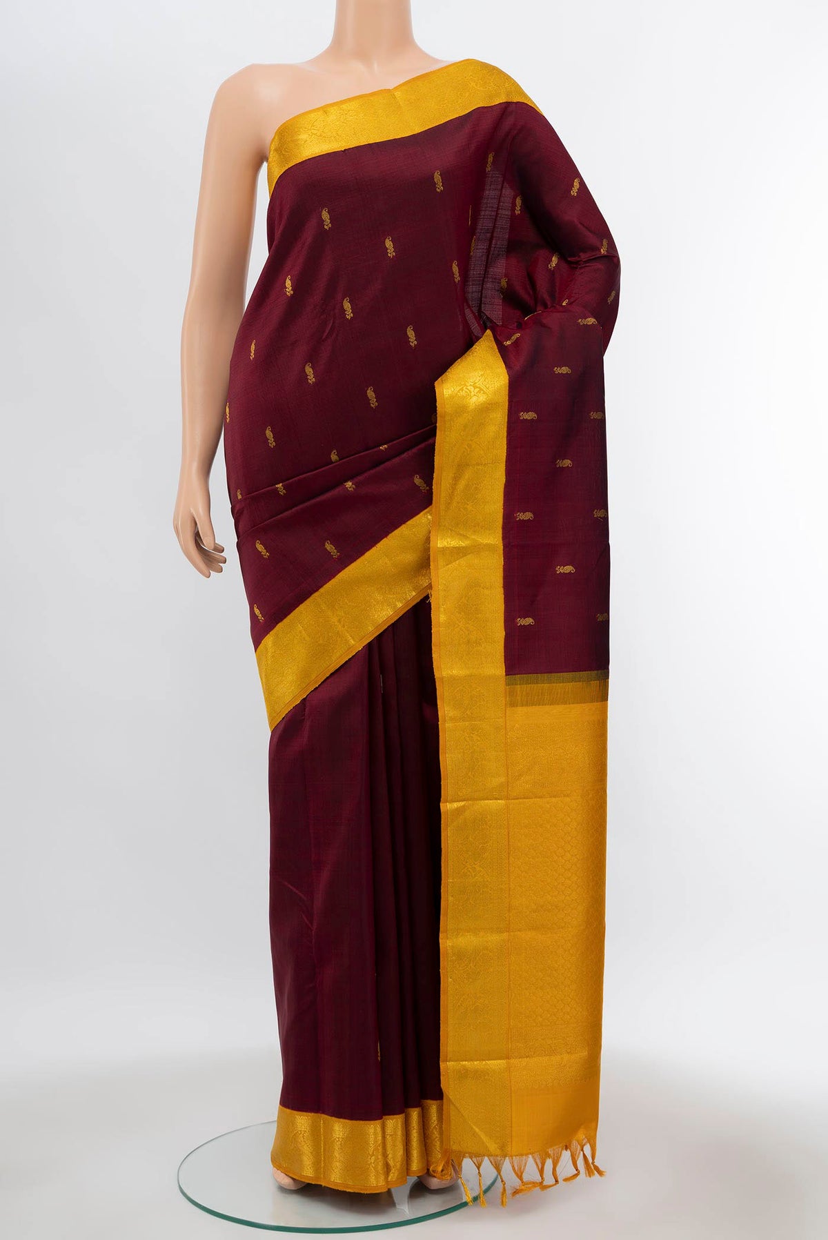Maroon Kanchipuram Silk Saree with Plain Body and Zari Border displayed on a mannequin