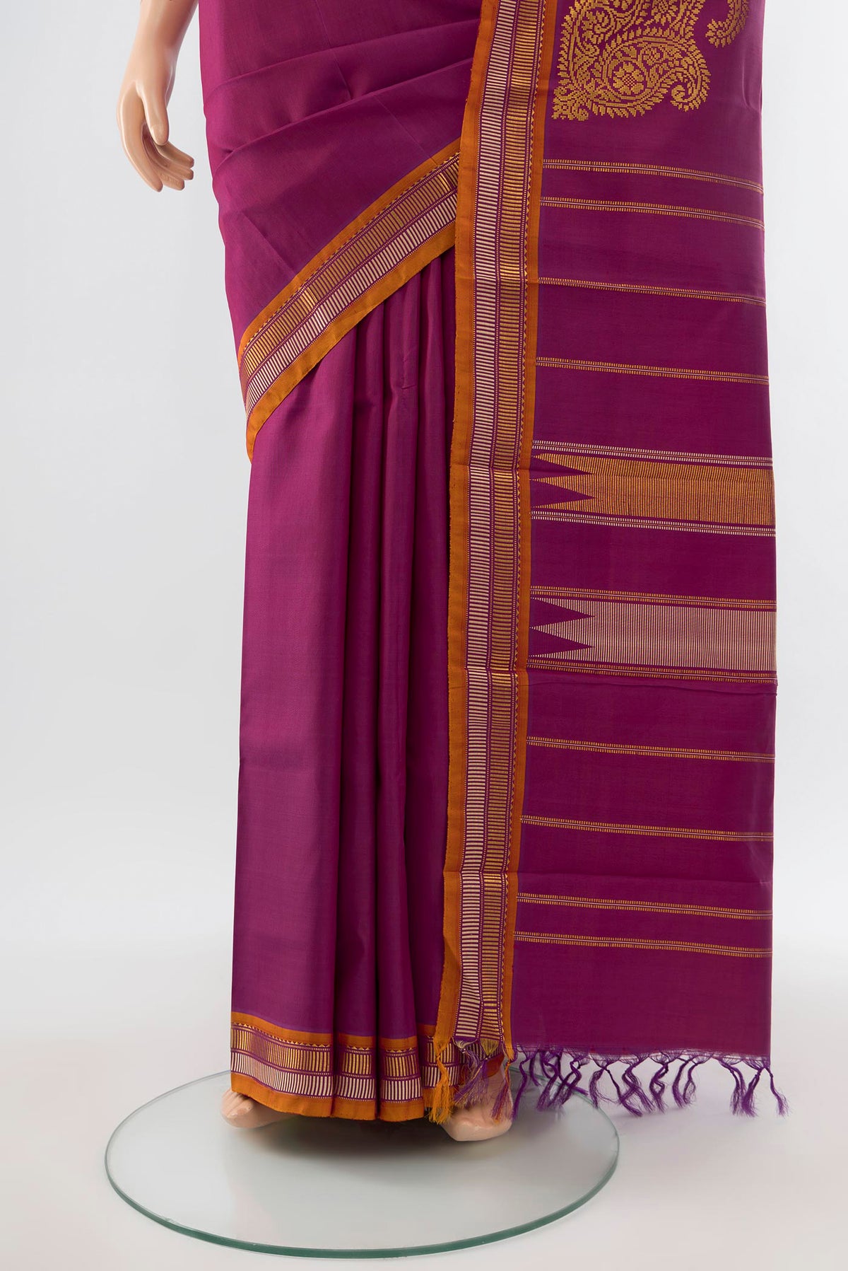 Pleats and pallu of Purple Kanchipuram Silk Saree with Zari Butta on the body and Silk Border. 