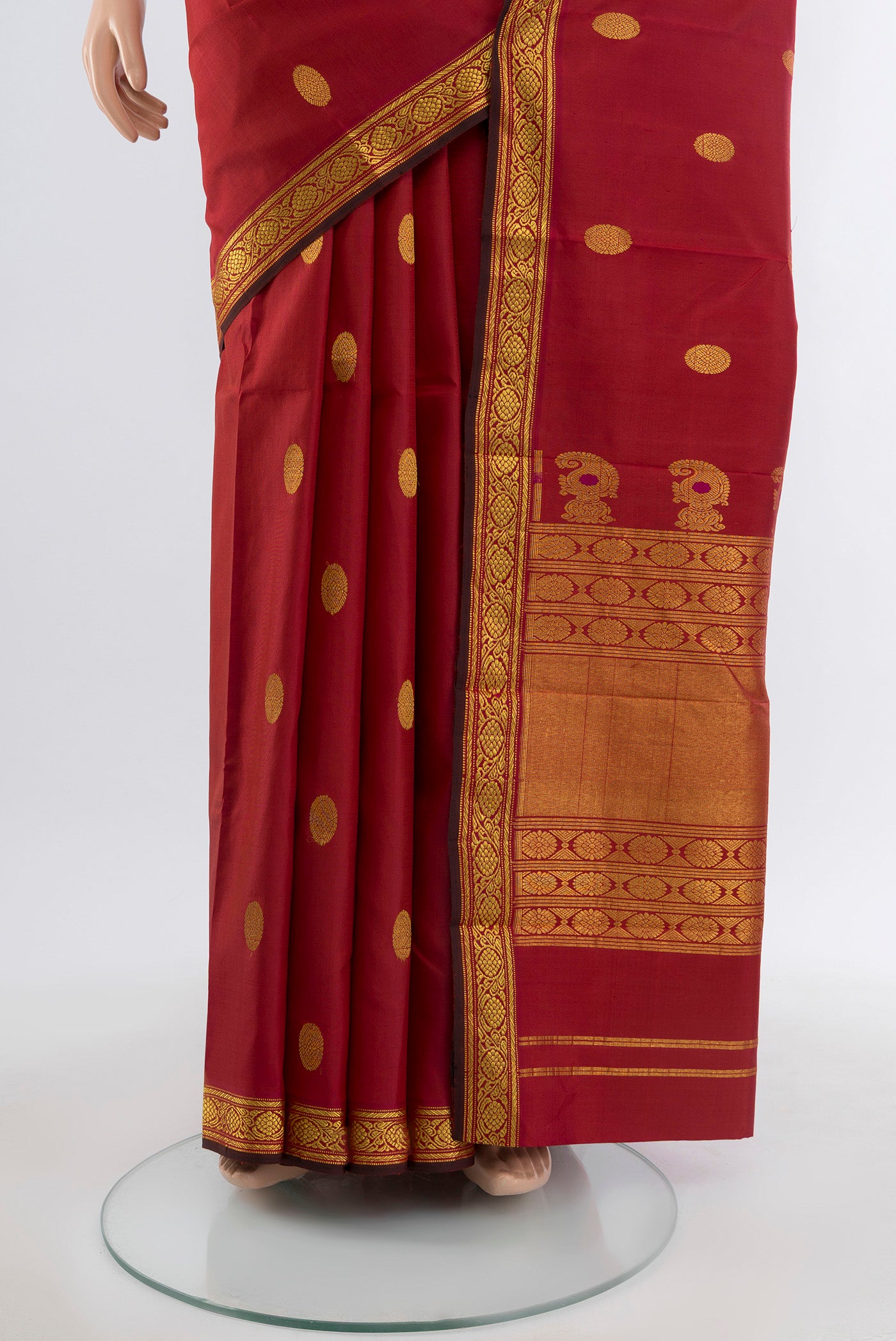 Pleats and pallu of Maroon Kanjivaram Silk Saree with Zari Butta on the body and Silk Border. 