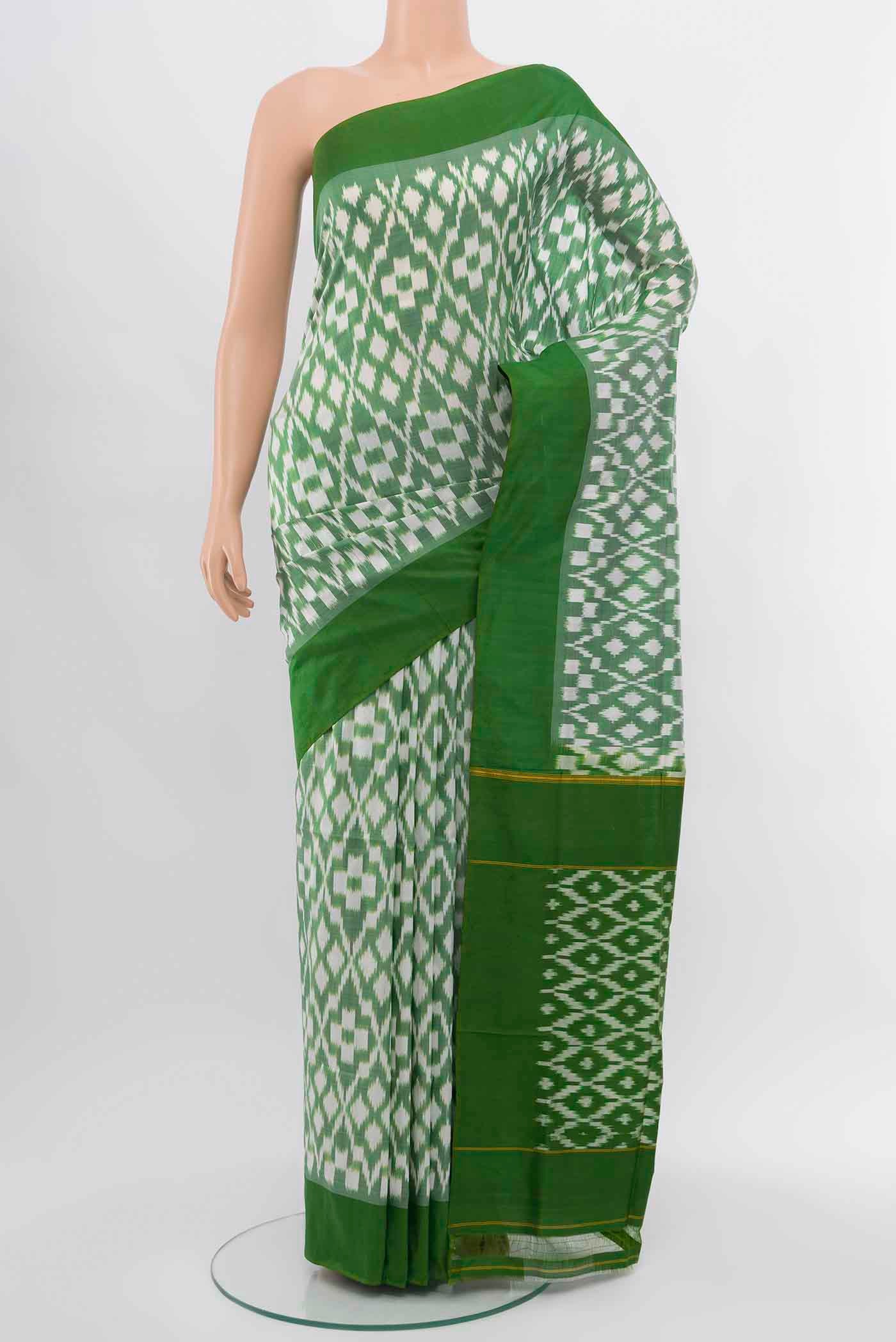 Light Green Pochampally Silk Saree with Zari Butta on the body and Silk Border.  displayed on a mannequin