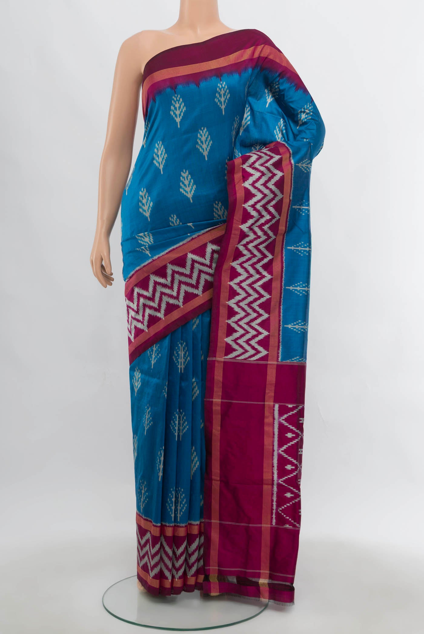 Dark Blue Pochampally Saree with Ikat Print on the body and Zari Border.  displayed on a mannequin