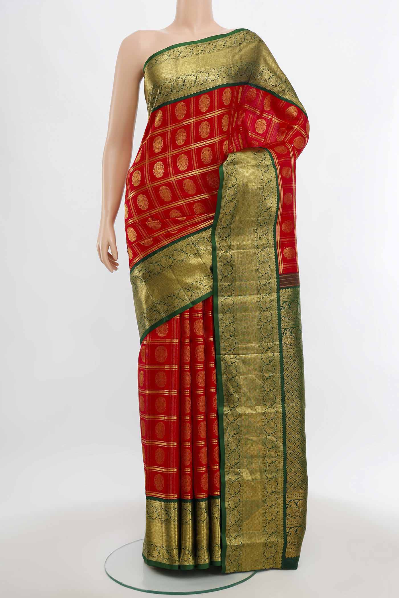 Red Kanchipuram Silk Saree with Zari Butta on the body and Silk Border.  displayed on a mannequin