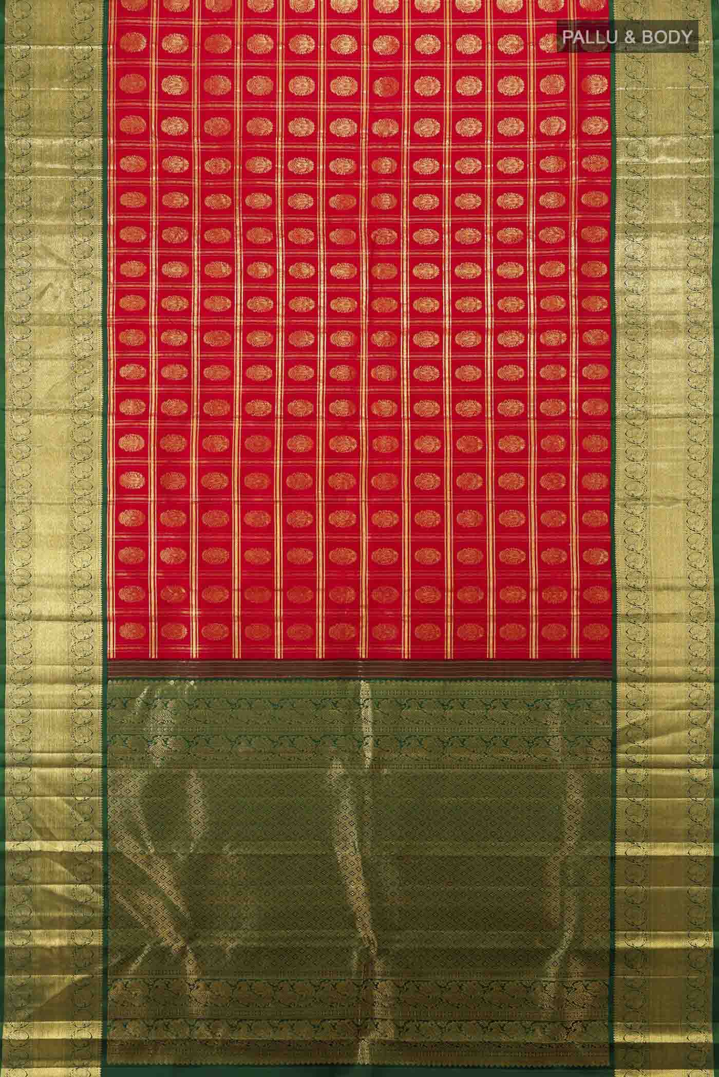 Flat view of Red Kanchipuram Silk Saree with Zari Butta on the body and Silk Border. 