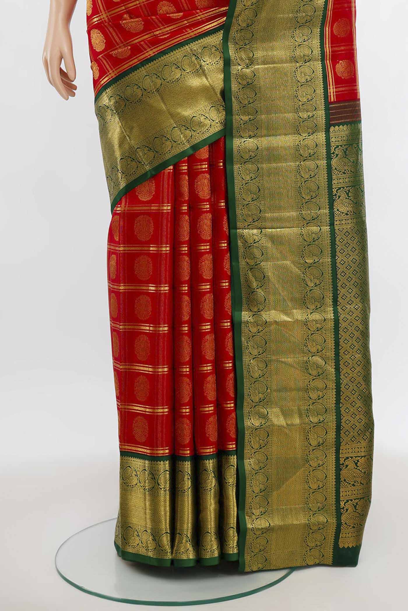 Pleats and pallu of Red Kanchipuram Silk Saree with Zari Butta on the body and Silk Border. 