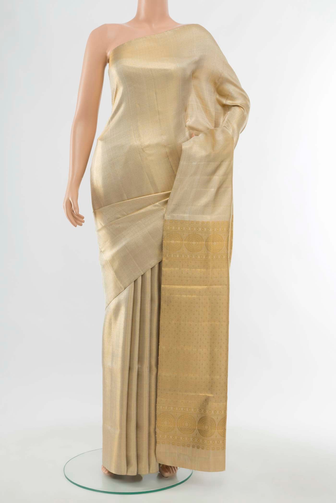 Golden Kanchipuram Silk Saree with Zari Butta on the body and Silk Border displayed on a mannequin