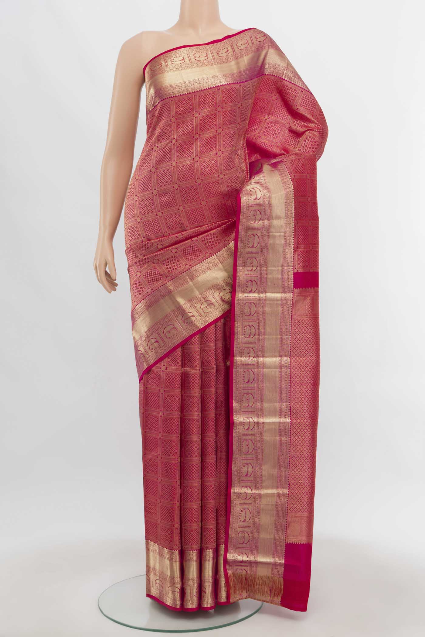 Dark Pink Kanchipuram Silk Saree with Zari Butta on the body and Zari Border.  displayed on a mannequin