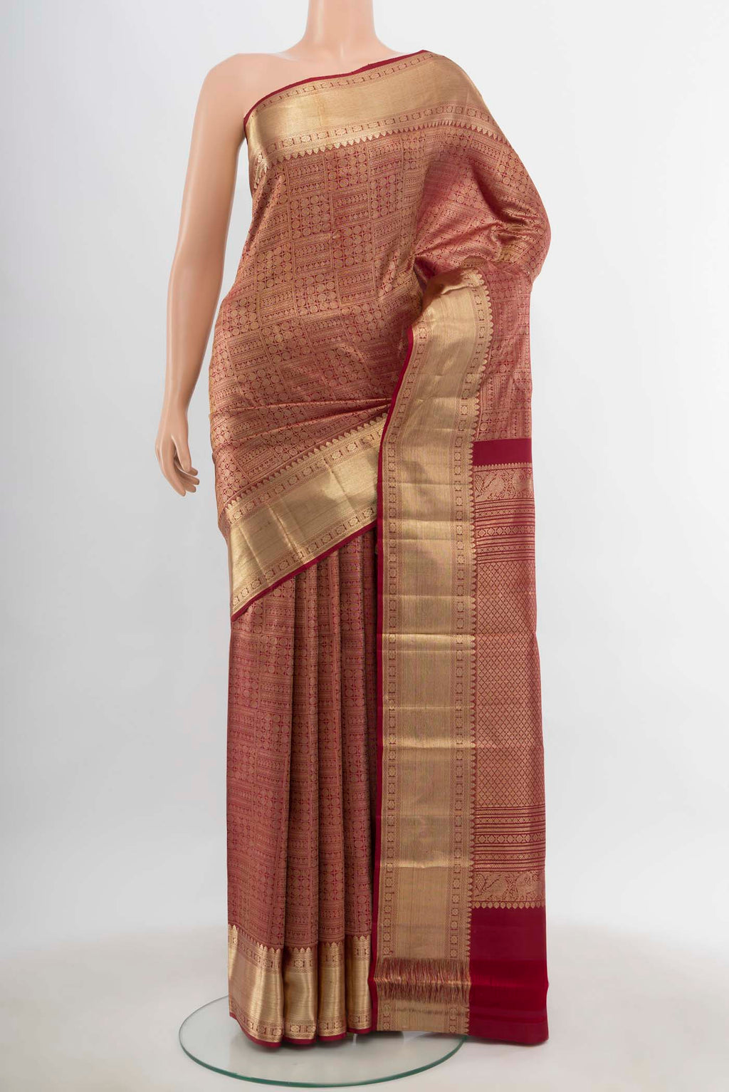 Maroon Kanchipuram Silk Saree with Zari Butta on the body and Silk Border.  displayed on a mannequin