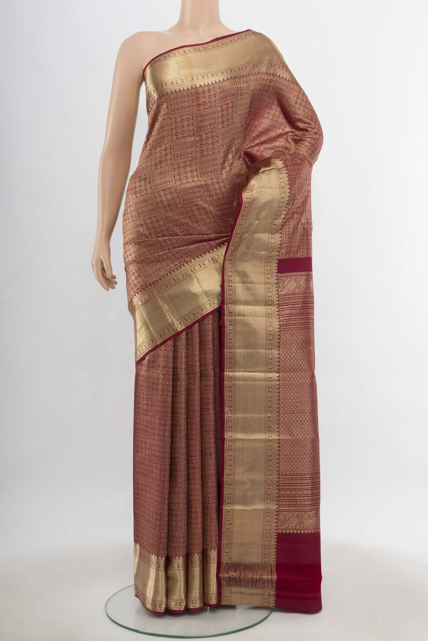 Maroon Kanchipuram Silk Saree with Zari Butta on the body and Silk Border.  displayed on a mannequin