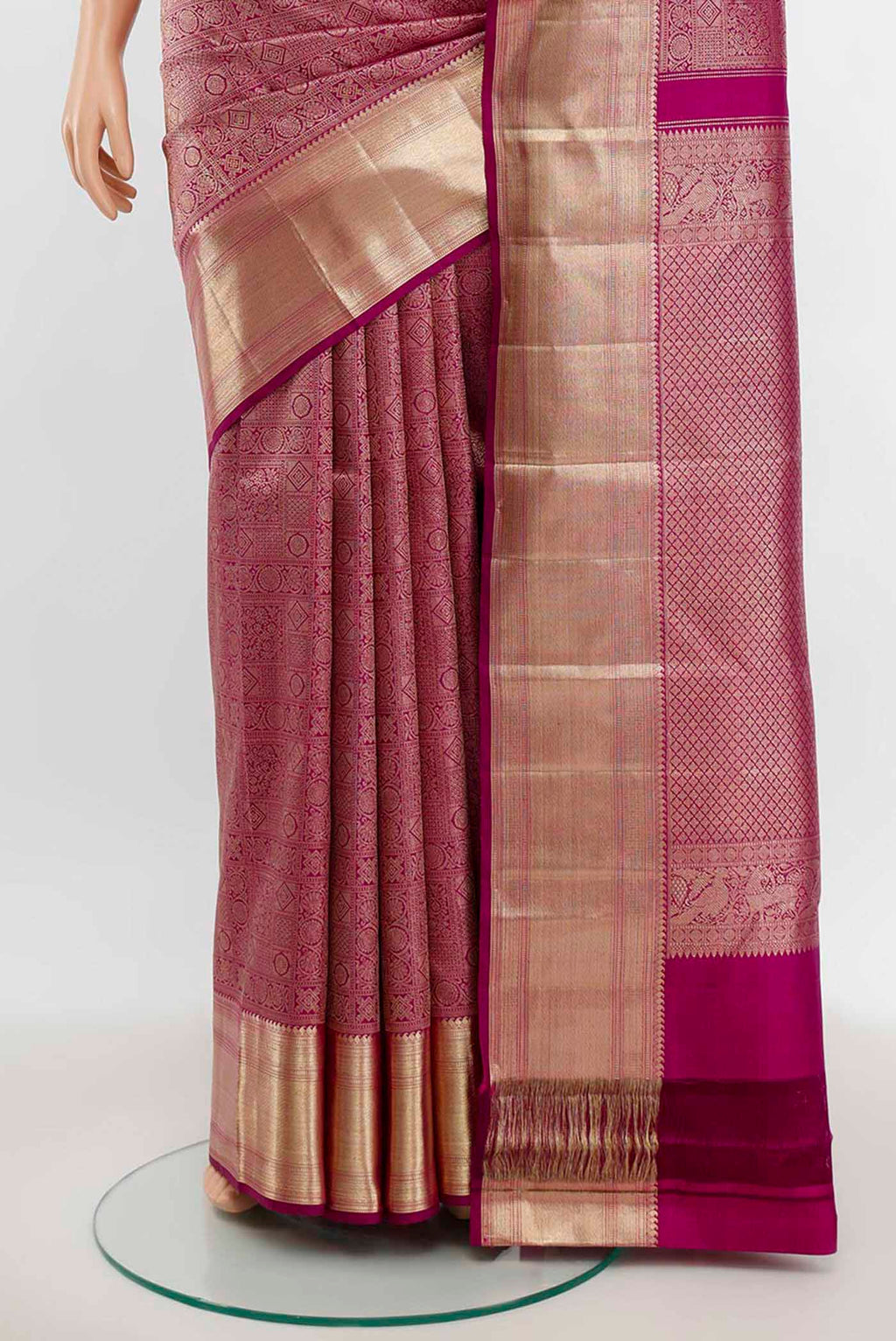 Pleats and pallu of Purple Kanchipuram Silk Saree with Zari Butta on the body and Silk Border. 