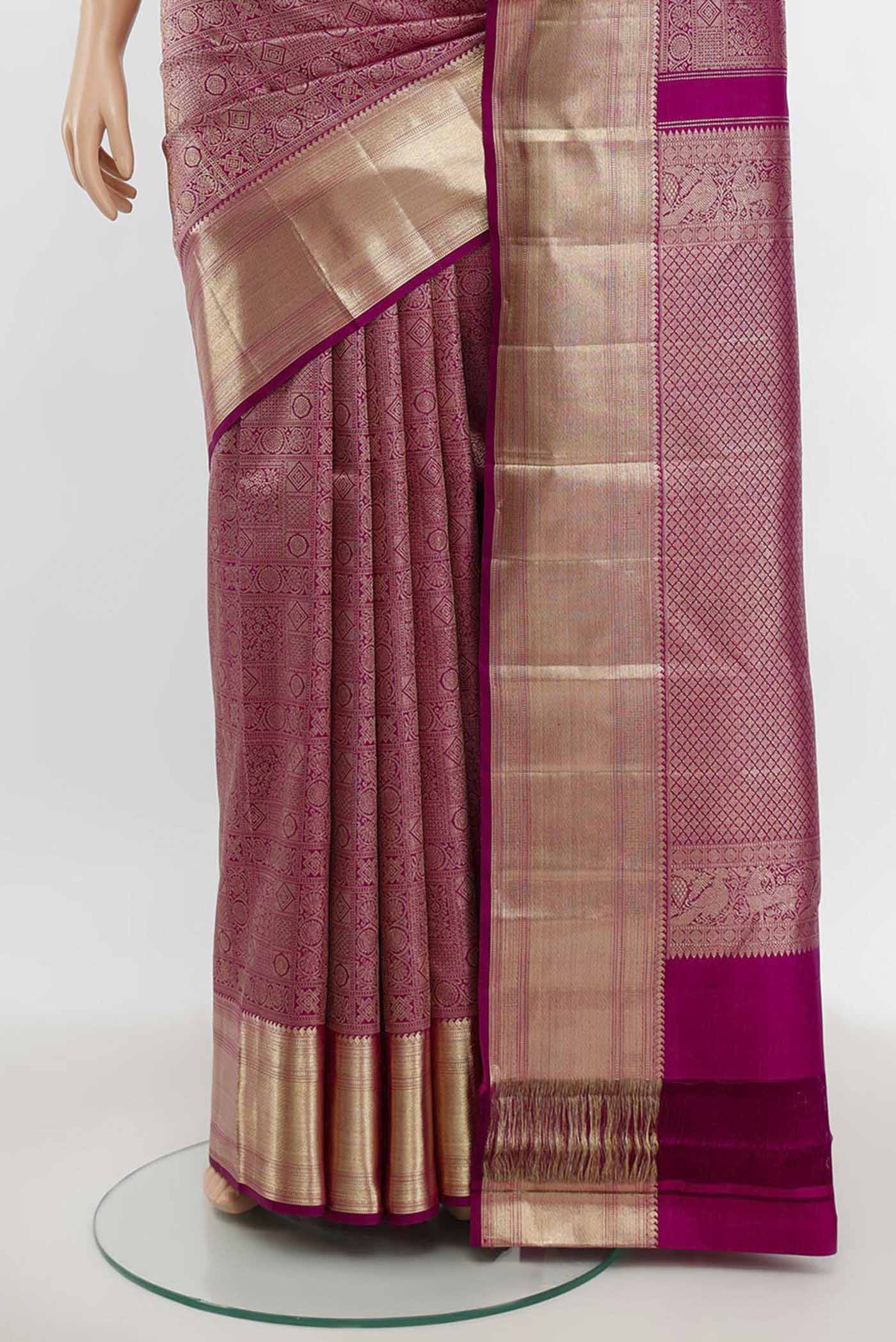 Pleats and pallu of Purple Kanchipuram Silk Saree with Zari Butta on the body and Silk Border. 