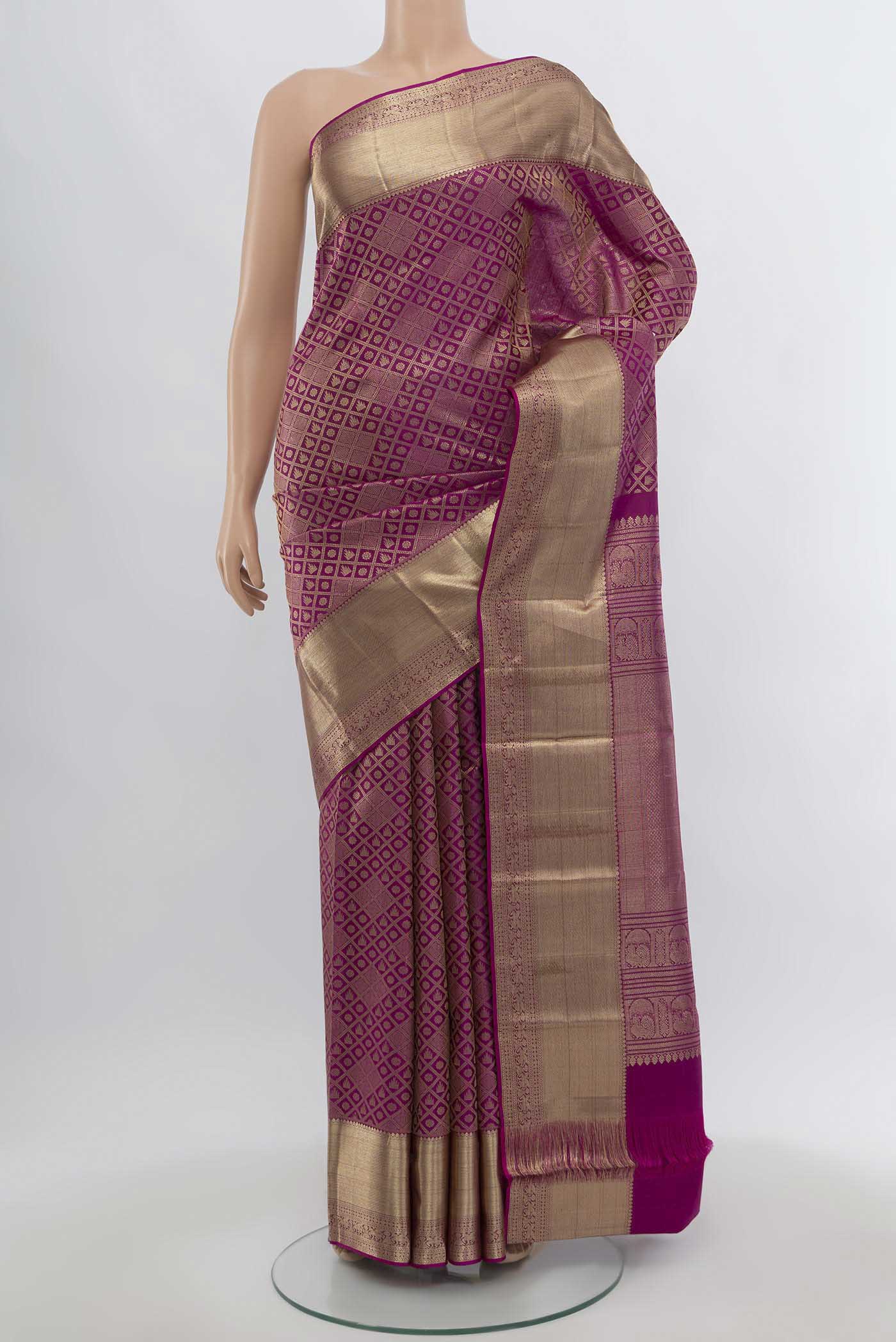 Magenta Kanchipuram Silk Saree with Zari Butta on the body and Silk Border.  displayed on a mannequin