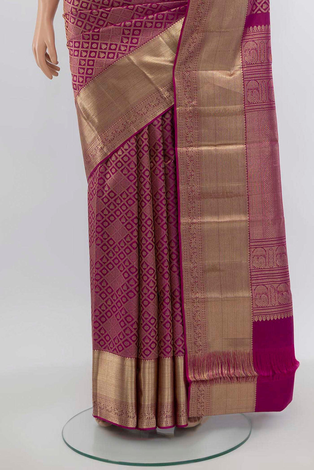 Pleats and pallu of Magenta Kanchipuram Silk Saree with Zari Butta on the body and Silk Border. 