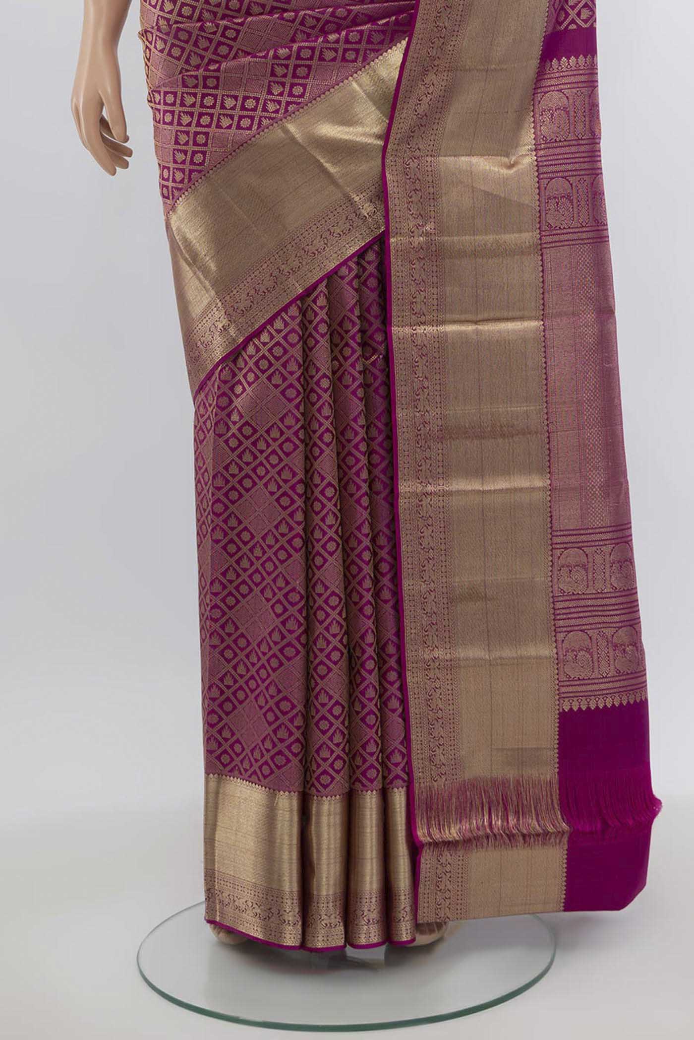 Pleats and pallu of Magenta Kanchipuram Silk Saree with Zari Butta on the body and Silk Border. 