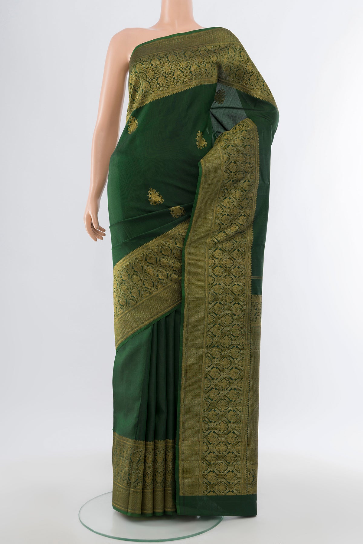 Pure Silk Pure Zari Bottle Green Kanjivaram Saree with Zari Butta on the body and Silk Border.  displayed on a mannequin